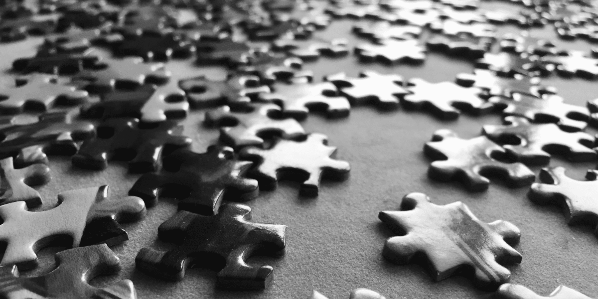 Black and white photo of puzzle pieces on a table