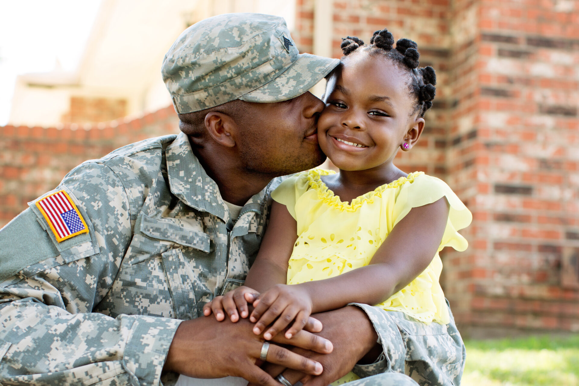 Stock image of a real father in the U.S. military with her daughter. Natural light.