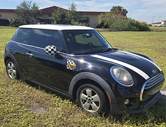 Black 2-door Mini Cooper with White Stripes