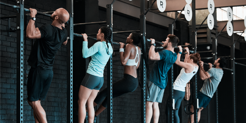 A Group of people, men and women doing pull-ups